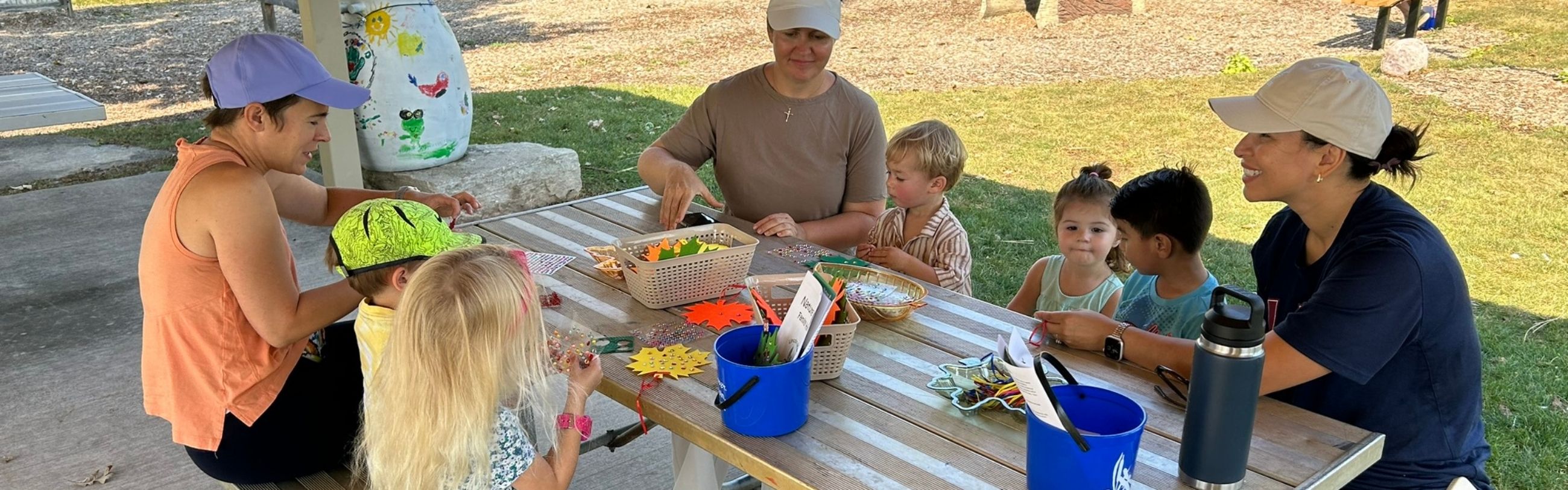 Families with their children creating crafts at Prairie Patch Play Area