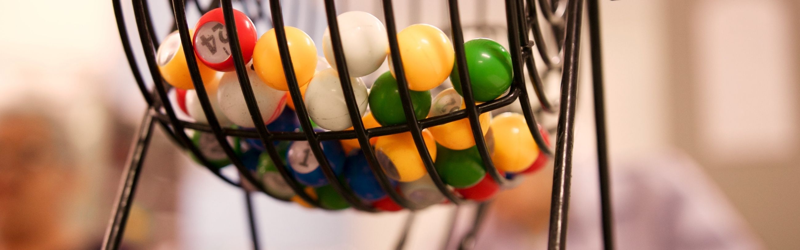 rotary bingo cage with colorful numbered balls inside