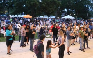 Tents and a Large crowd having fun at Cream of Wheaton Event.