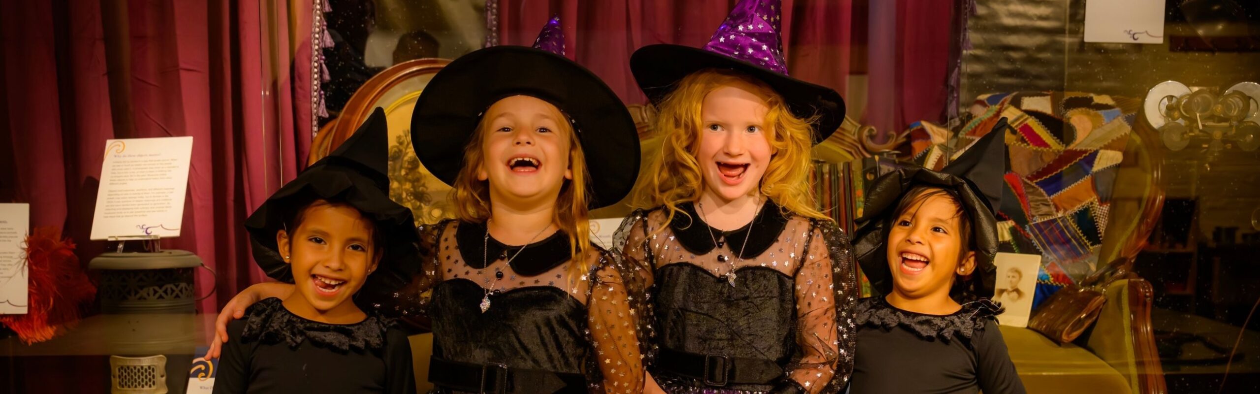 four children dressed up as wizards and witches