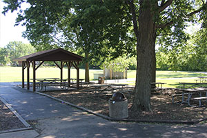 Park shelter with playground in the background