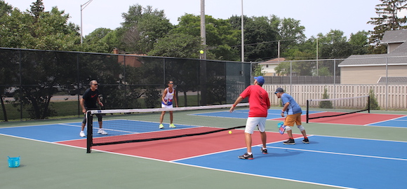 4 people playing pickleball