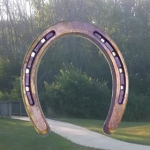 The Sensory Arch, an eight-foot-tall steel horseshoe, will span the walkway into the playground starting in 2016.