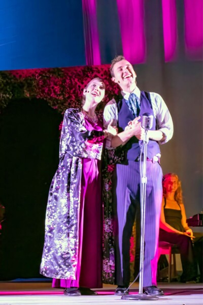 Shakespeare_in_the_park Woman and men singing on stage during Shakespeare in the Park event