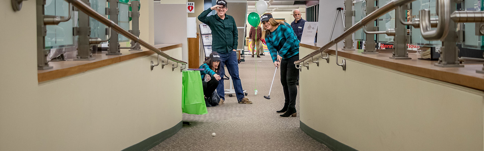 Group of People playing mini golf at Wheaton Public Library