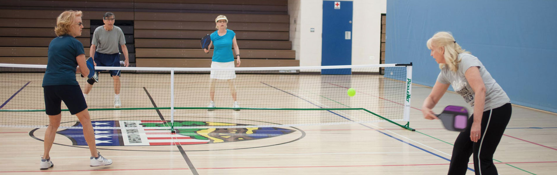 Group of people playing indoor pickleball